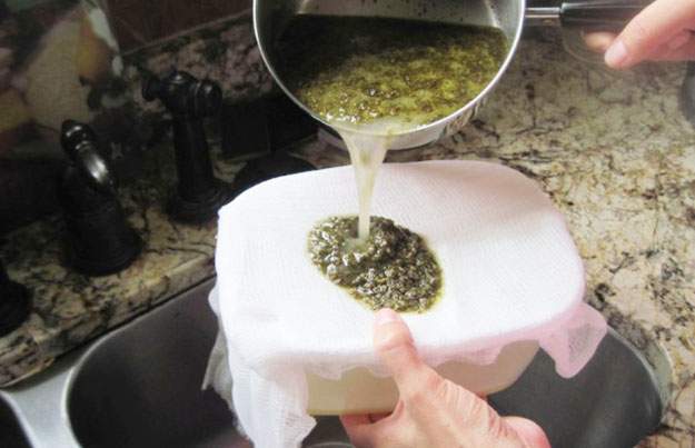 straining cannabis broth to produce hemp ointment